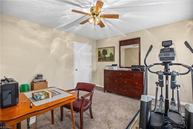 home office featuring a textured ceiling, light colored carpet, and ceiling fan