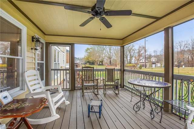 sunroom with ceiling fan and wood ceiling