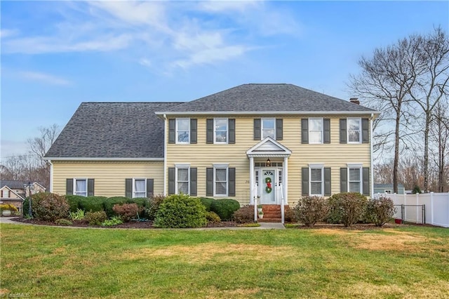 colonial-style house with a front lawn