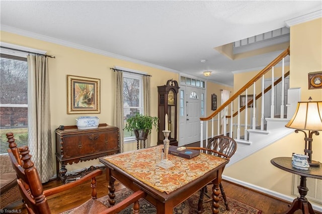 dining room with wood-type flooring and crown molding