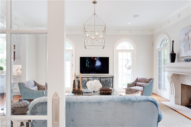 living room featuring hardwood / wood-style floors, crown molding, and an inviting chandelier