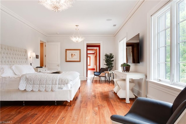 bedroom with light hardwood / wood-style floors, multiple windows, and a chandelier