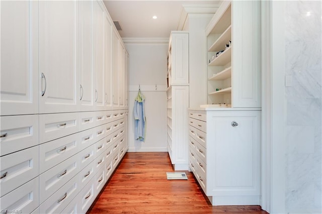 walk in closet featuring light hardwood / wood-style floors