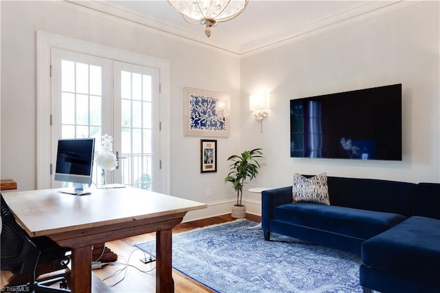 office area featuring french doors, crown molding, a notable chandelier, and hardwood / wood-style floors