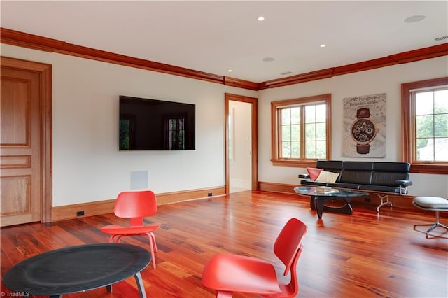 living room with ornamental molding and hardwood / wood-style flooring