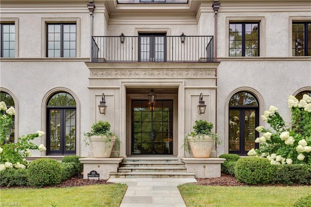 property entrance featuring french doors and a balcony