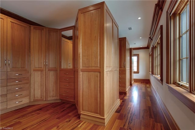 interior space featuring hardwood / wood-style floors and crown molding