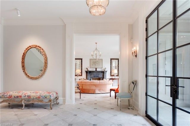 hallway with an inviting chandelier and ornamental molding