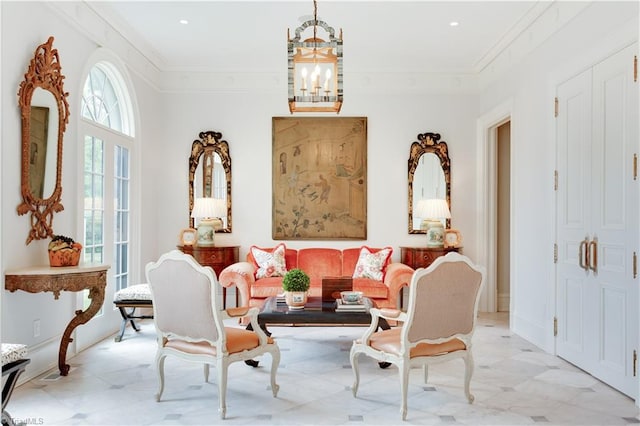 living area featuring crown molding and an inviting chandelier