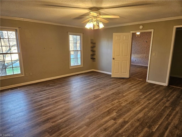 empty room featuring ceiling fan, dark wood-type flooring, and a textured ceiling