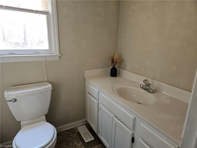 bathroom with tile patterned flooring, vanity, and toilet