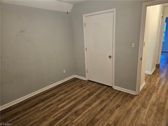 unfurnished bedroom featuring dark hardwood / wood-style floors