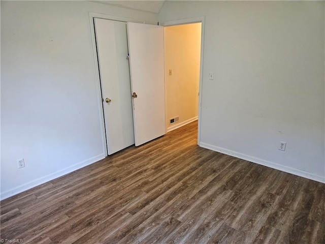 spare room featuring dark hardwood / wood-style floors