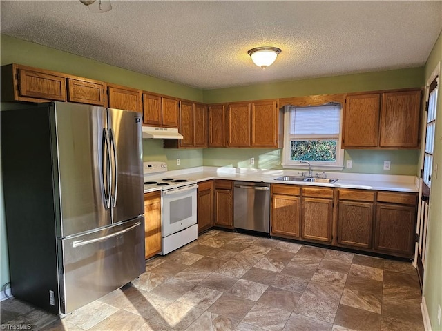 kitchen featuring a textured ceiling, sink, and stainless steel appliances