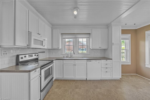 307 S Key St, Pilot Mountain, NC 27041 - kitchen with white appliances, a sink, plenty of natural light, white cabinetry, and ornamental molding