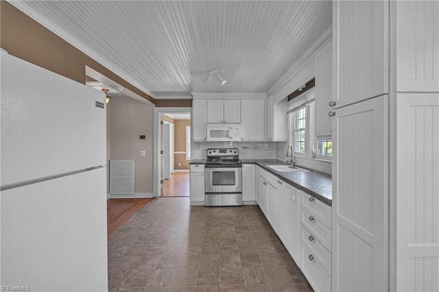 307 S Key St, Pilot Mountain, NC 27041 - kitchen with white appliances, a sink, white cabinets, backsplash, and ornamental molding