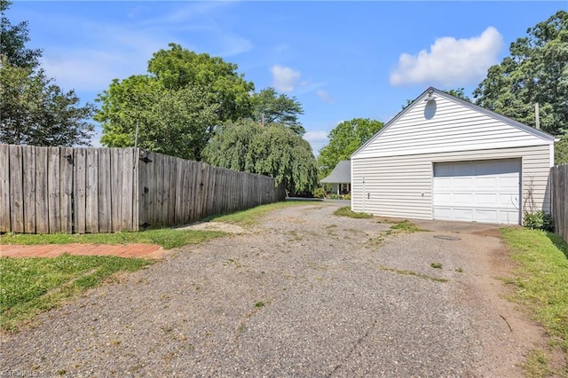 307 S Key St, Pilot Mountain, NC 27041 - view of side of property featuring asphalt driveway, a detached garage, and an outdoor structure