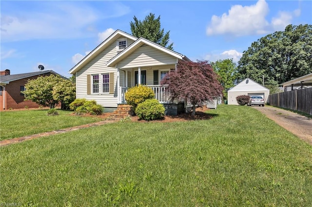 307 S Key St, Pilot Mountain, NC 27041 - view of front facade featuring covered porch, a detached garage, an outbuilding, and driveway
