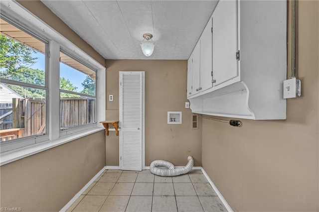 307 S Key St, Pilot Mountain, NC 27041 - laundry area featuring cabinet space, baseboards, electric dryer hookup, and light tile patterned floors