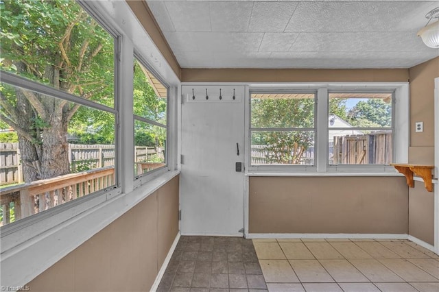 307 S Key St, Pilot Mountain, NC 27041 - unfurnished sunroom with baseboards and tile patterned flooring