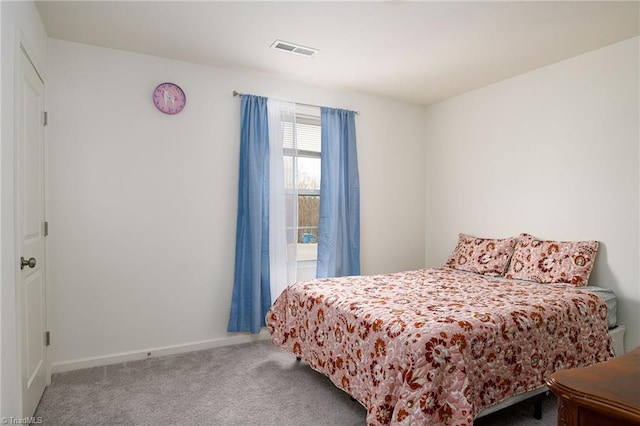 carpeted bedroom featuring baseboards and visible vents