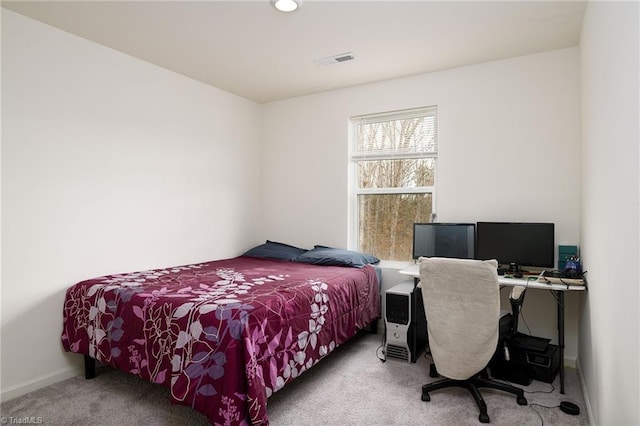 carpeted bedroom featuring baseboards and visible vents