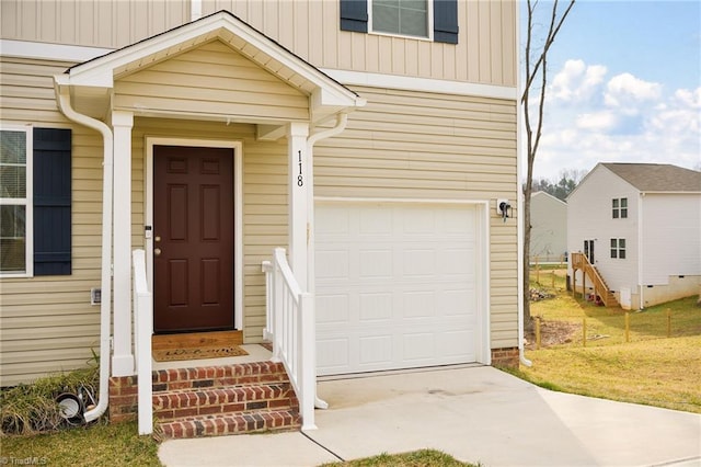 entrance to property with a garage and driveway