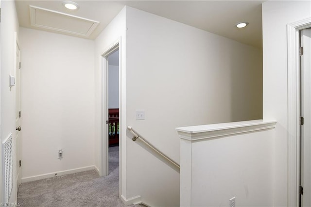 hallway featuring recessed lighting, carpet flooring, an upstairs landing, baseboards, and attic access