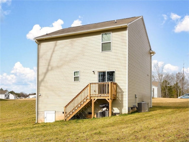 back of house with stairs, crawl space, a lawn, and central air condition unit