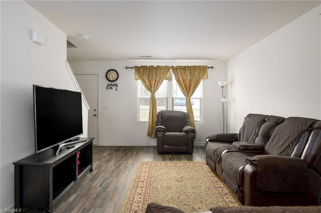 living area with wood finished floors and baseboards