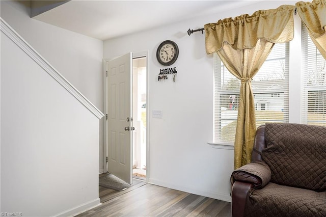 sitting room featuring baseboards and wood finished floors