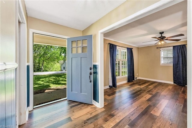 foyer entrance with ceiling fan, wood finished floors, and baseboards