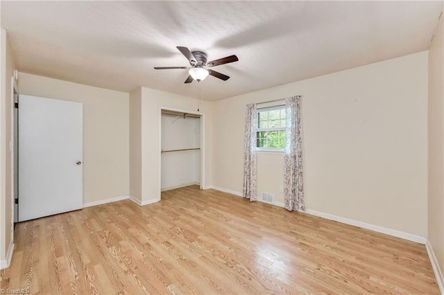 unfurnished bedroom featuring baseboards, visible vents, and light wood finished floors