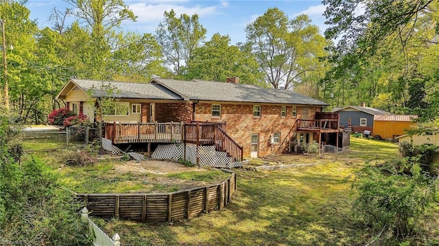 back of house featuring a chimney, stairs, a wooden deck, and a fenced backyard