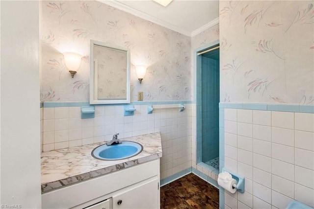 full bathroom with ornamental molding, tile walls, wallpapered walls, and vanity