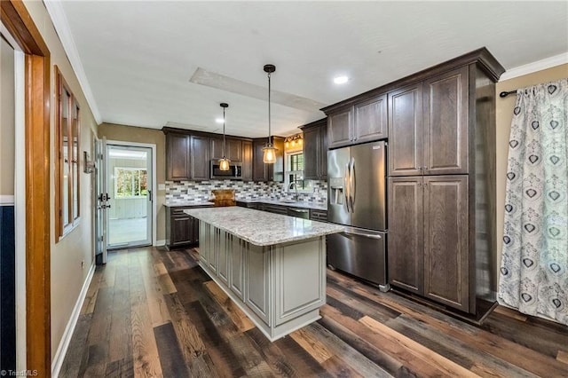 kitchen with dark brown cabinetry, stainless steel appliances, a kitchen island, backsplash, and dark wood-style floors