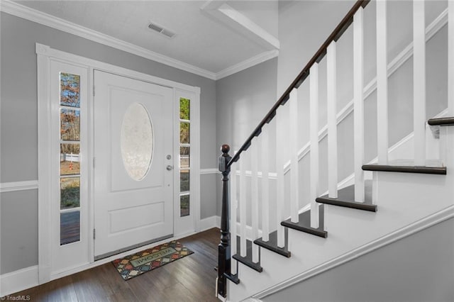 foyer entrance featuring dark wood-type flooring and ornamental molding