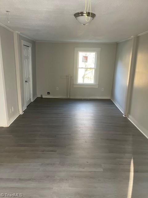 unfurnished room featuring dark hardwood / wood-style floors and a textured ceiling