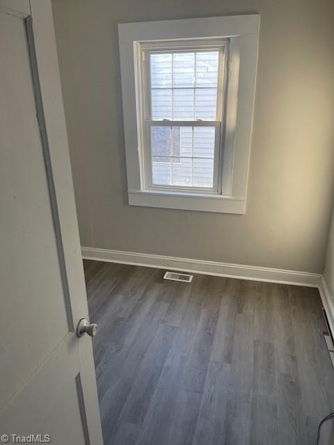 empty room featuring dark wood-type flooring