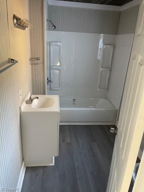 bathroom featuring shower / tub combination, wood-type flooring, and vanity