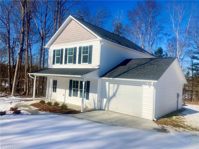 view of property with covered porch and a garage