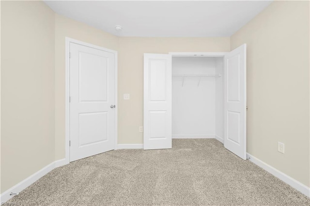 unfurnished bedroom featuring a closet and carpet