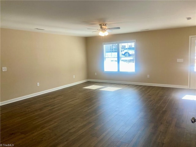 empty room featuring ceiling fan and dark hardwood / wood-style floors