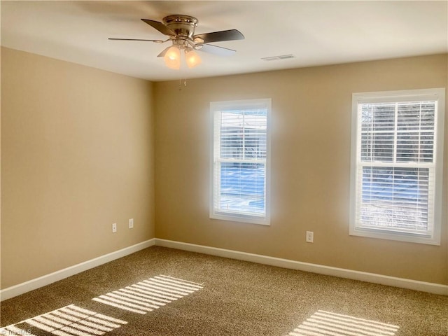 spare room featuring ceiling fan and carpet flooring