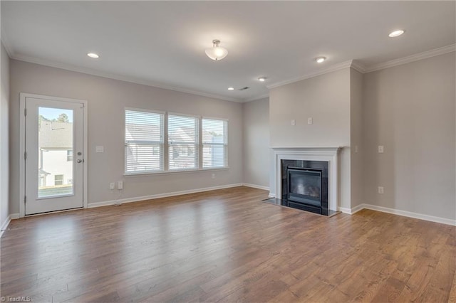 unfurnished living room with ornamental molding and wood-type flooring