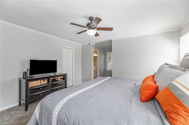 carpeted bedroom with ensuite bathroom, baseboards, ceiling fan, and crown molding