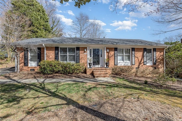 ranch-style house with crawl space, brick siding, roof with shingles, and a front yard