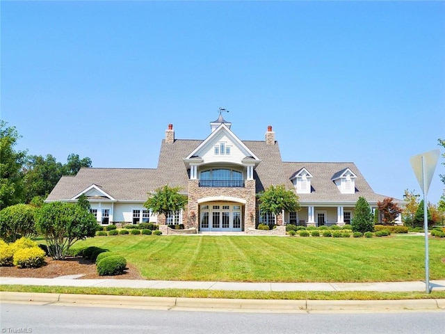 view of front facade featuring a front lawn and french doors