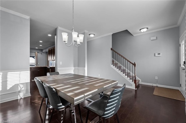 dining area with dark hardwood / wood-style flooring, ornamental molding, and an inviting chandelier