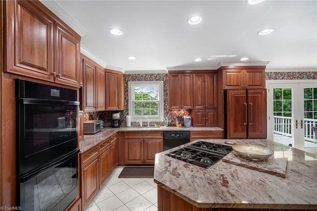 kitchen featuring light stone countertops, french doors, black appliances, and ornamental molding